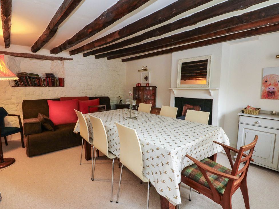 A dining room with a table and chairs at Sciora Cottage
