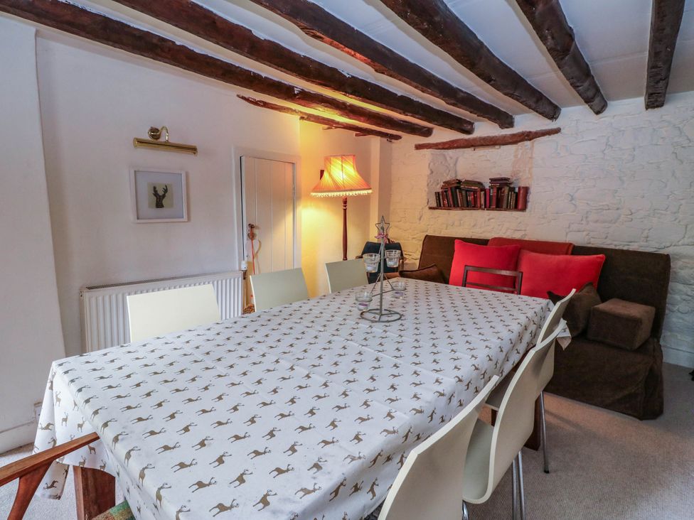 A dining room with a table and chairs in Sciora Cottage