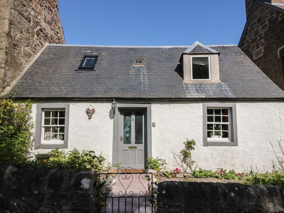 A house with a grey door and windows at Sciora Cottage in Crieff
