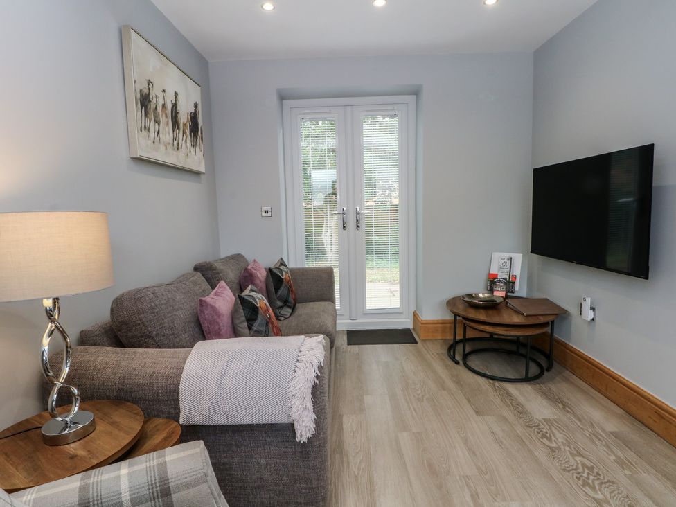 A living room with a sofa and television at Barn 1 Day Green near Rode Heath