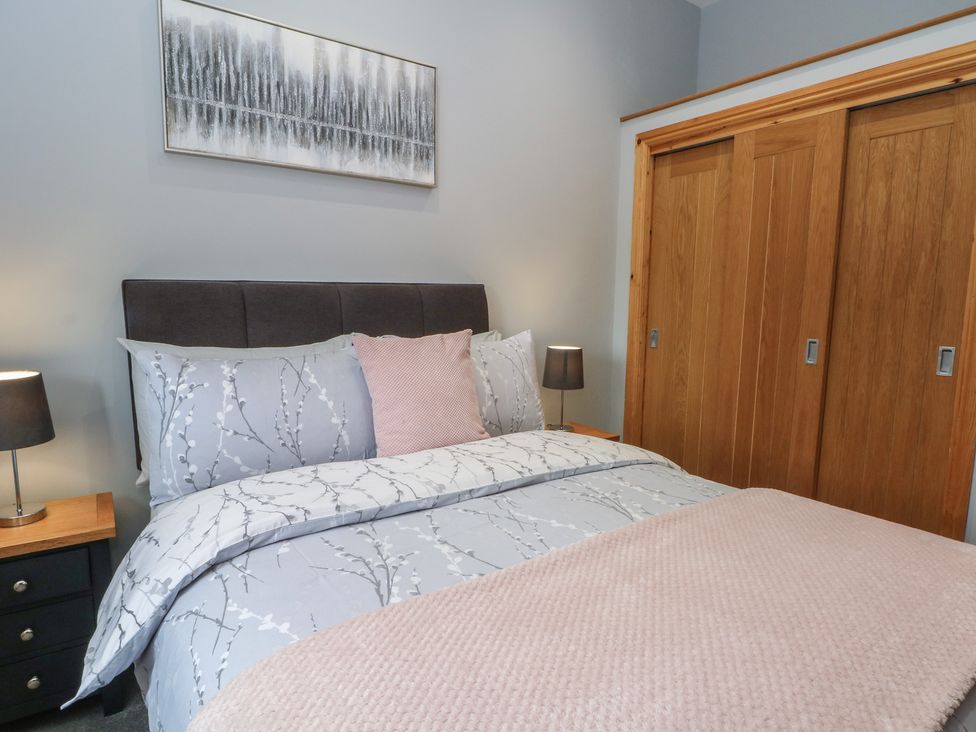 A bedroom with a bed and bedside lamps at Barn 1 Day Green near Rode Heath