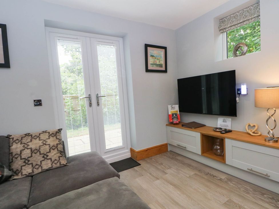 A living room with a sofa and television at Barn 2 in Day Green near Rode Heath