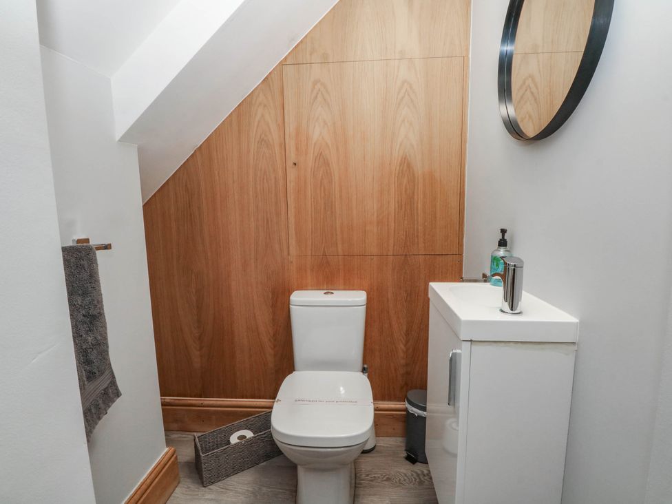 A small bathroom with a toilet and sink at Barn 2 Day Green near Rode Heath