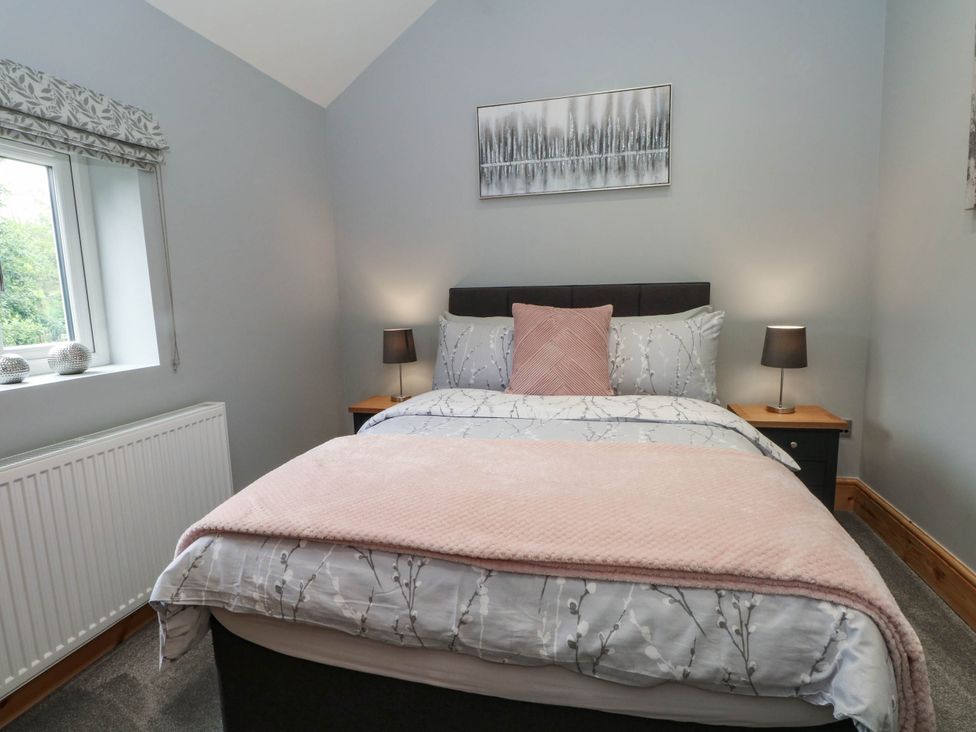 A bedroom with bed and bedside lamps at Barn 2 Day Green near Rode Heath