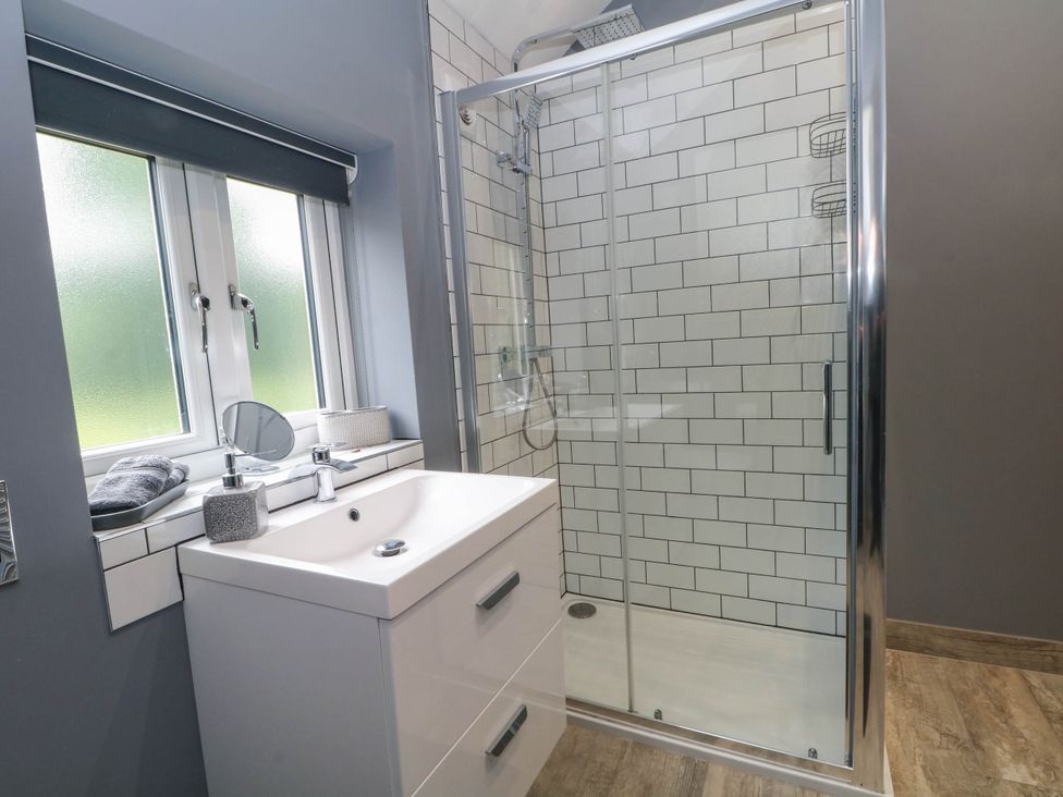 A bathroom with a shower and sink at Barn 2 Day Green near Rode Heath