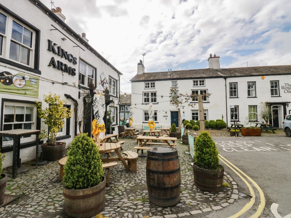 An outdoor area with tables and plants at Kings Arms pub