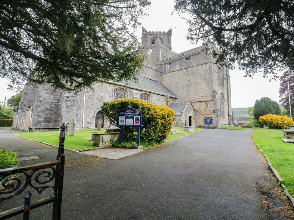 A church building with a pathway and greenery at Courtyard Cottage 
