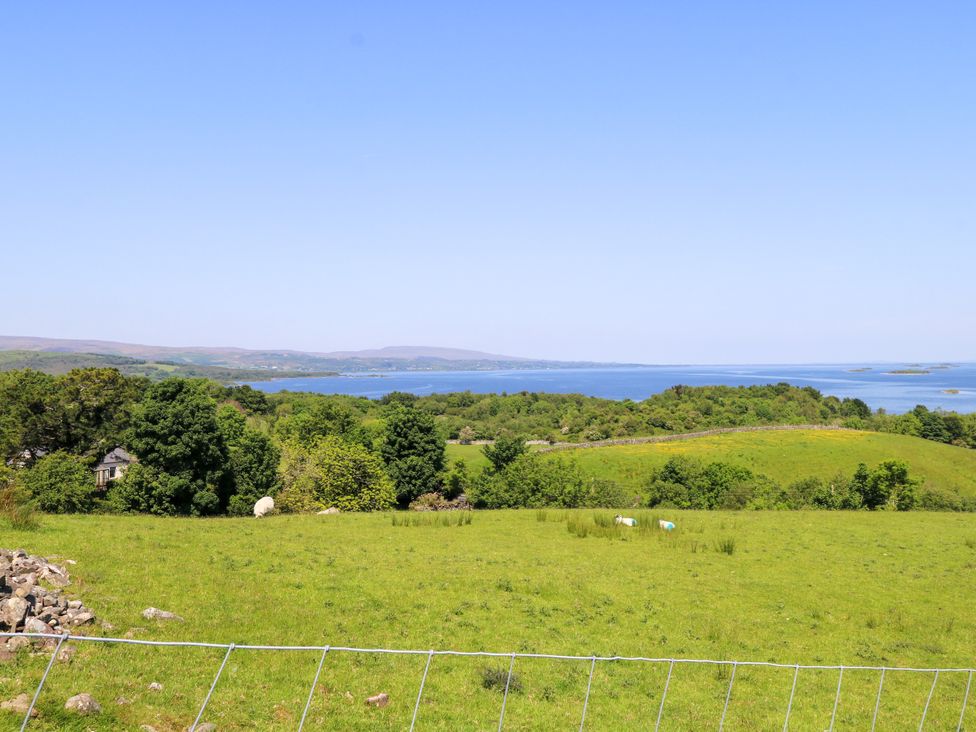 A landscape view with hills and a lake at Mayfly Cottage in 