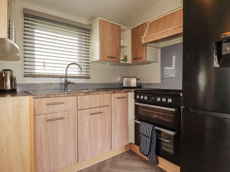 A kitchen with a sink and oven at Tucked Away in Newquay
