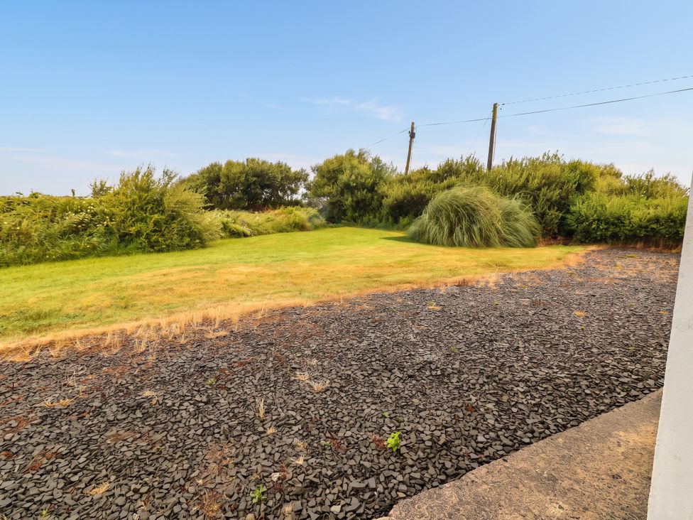 A garden area with grass and rocks at Golf Club View, County Clare