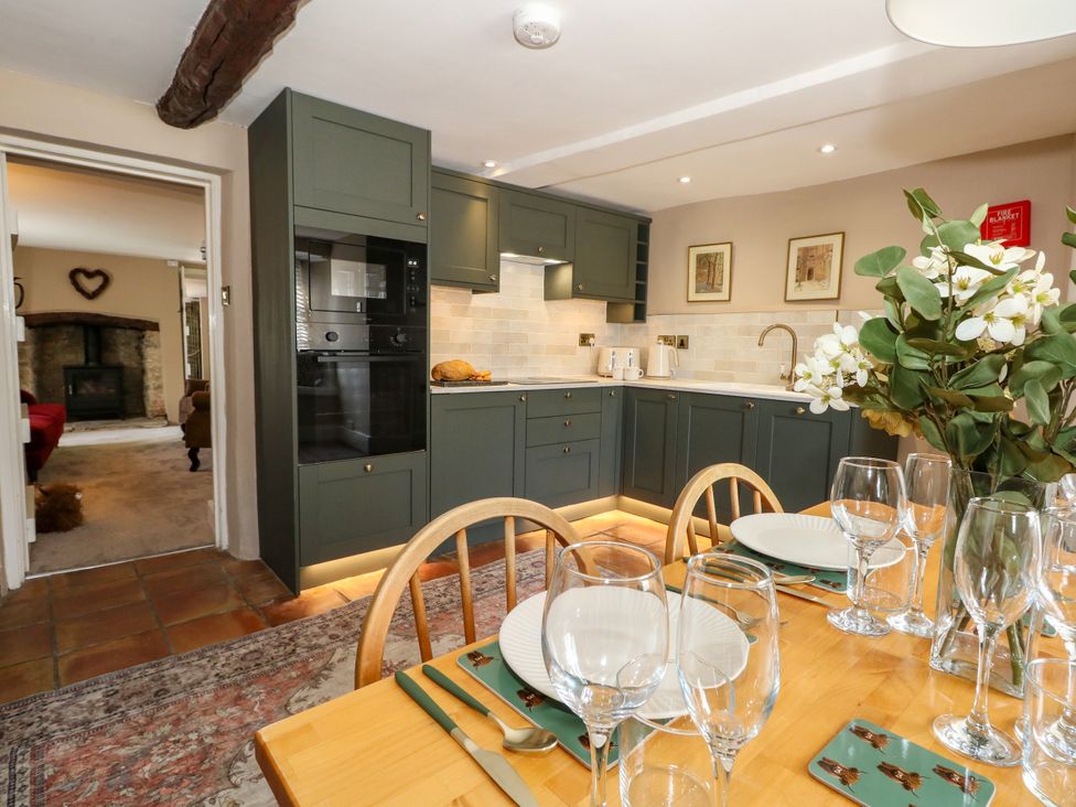 A kitchen with dining table and chairs at Little Wickers in Corfe Castle