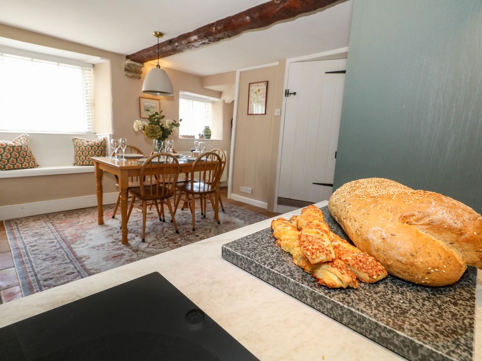 A dining room with a table and chairs at Little Wickers in Corfe Castle