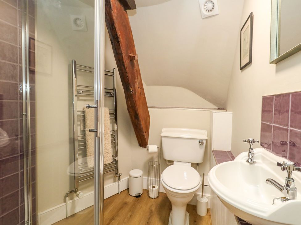 A bathroom with a shower, toilet and sink at Little Wickers in Corfe Castle
