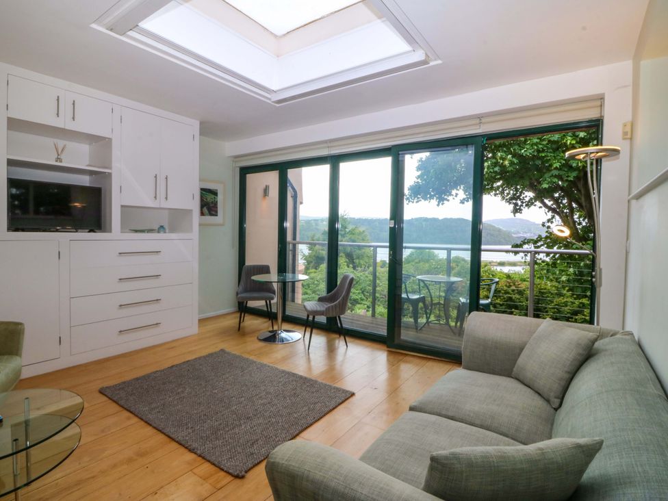 A living room with a sofa and a coffee table at The Treehouse in Colwyn Bay