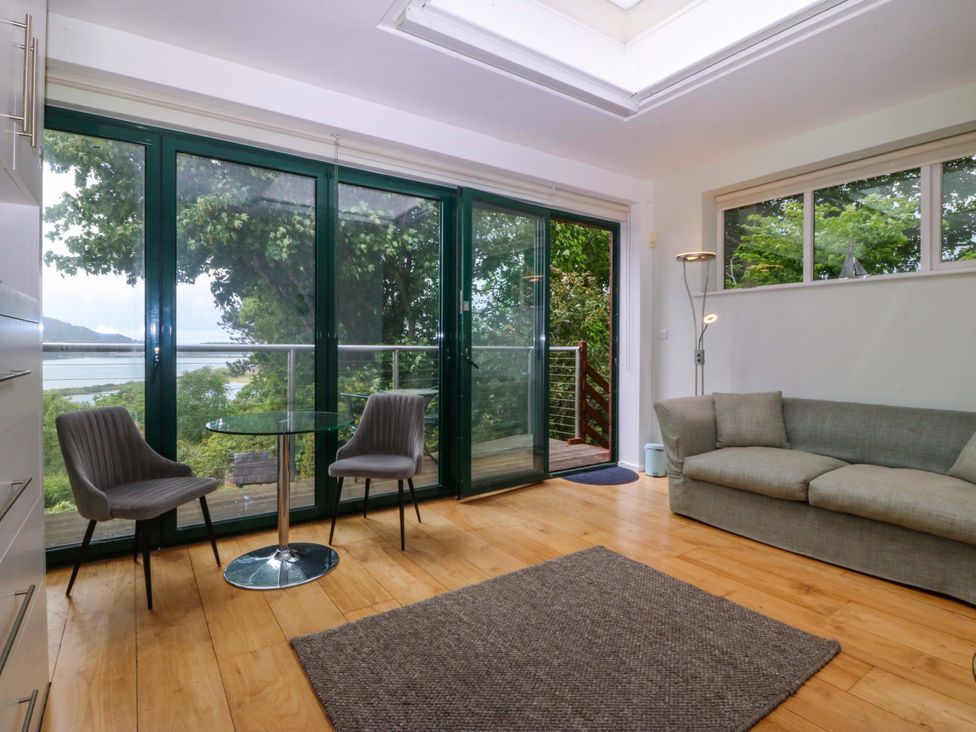 A living room with a sofa and a coffee table at The Treehouse in Colwyn Bay
