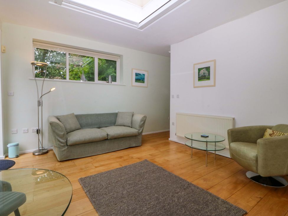 A living room with a sofa and coffee table at The Treehouse in Colwyn Bay