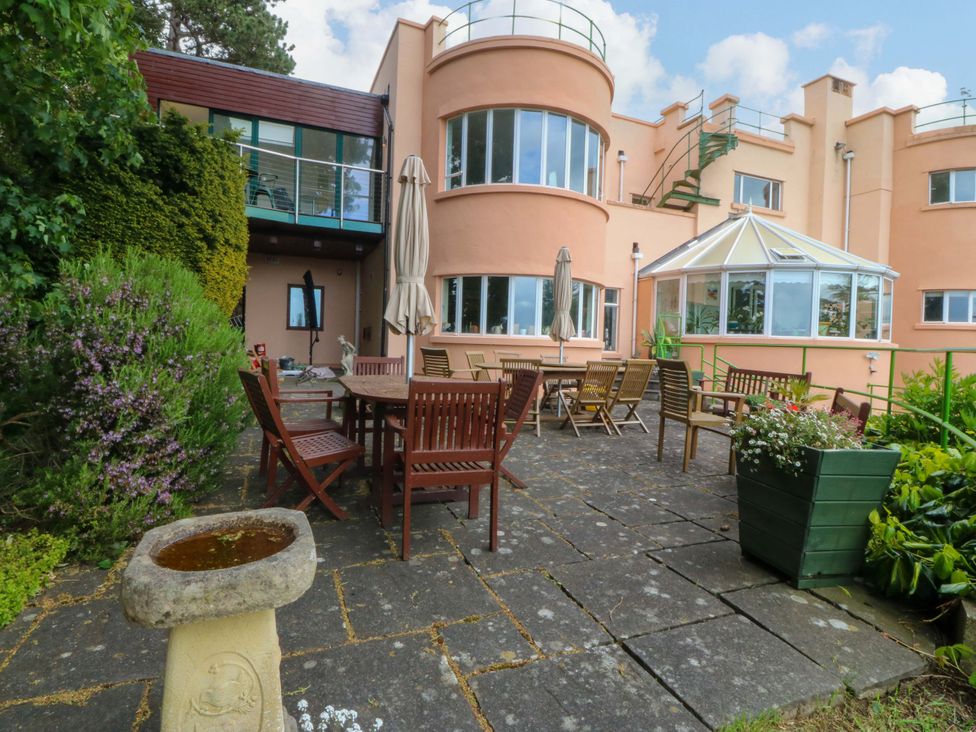 An outdoor area with a table and chairs at The Treehouse in Colwyn Bay