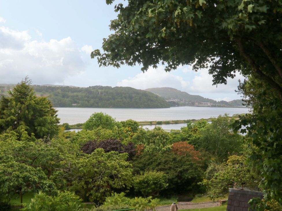 A view of a lake surrounded by trees and mountains at The Treehouse in Colwyn Bay