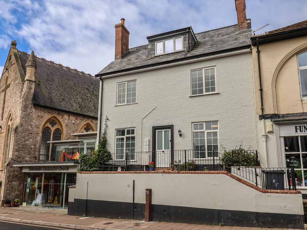 A building exterior with windows and a door at Flat 1 Harley House Sidmouth