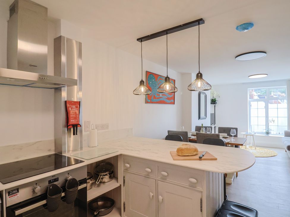 A kitchen with a stove and counter at Flat 1 Harley House Sidmouth