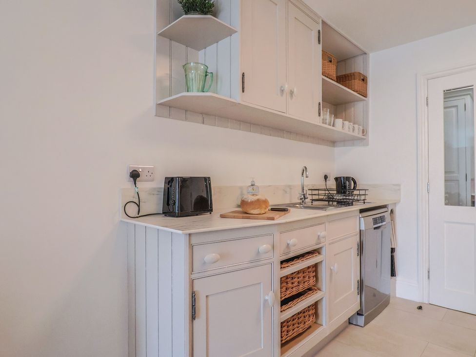 A kitchen with a sink and appliances at Flat 1 Harley House Sidmouth