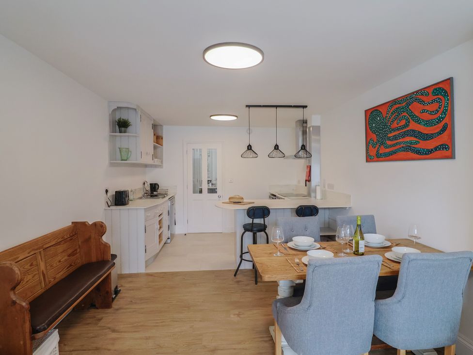 A dining room with a table set for dinner at Flat 1 Harley House Sidmouth