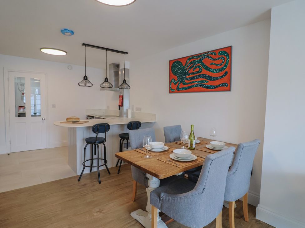 A dining room with a table and chairs at Flat 1 Harley House in Sidmouth