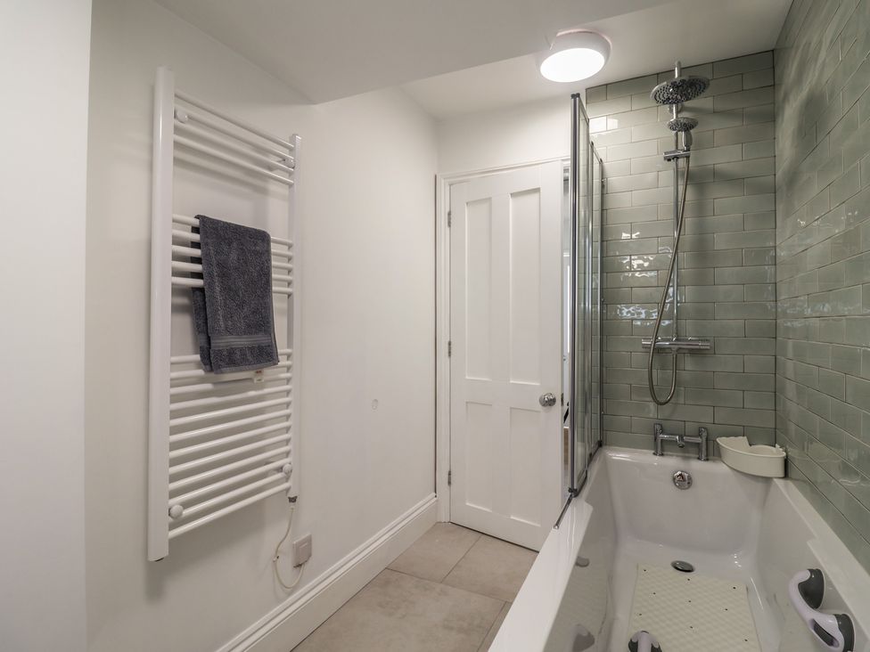 A bathroom with a bathtub and shower at Flat 1 Harley House in Sidmouth