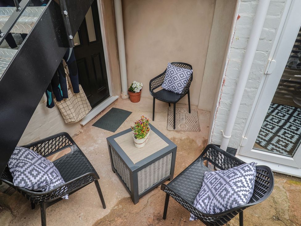 An outdoor area with chairs and a table at Flat 1 Harley House Sidmouth