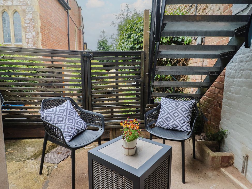 An outdoor seating area with two chairs and a table at Flat 1 Harley House Sidmouth