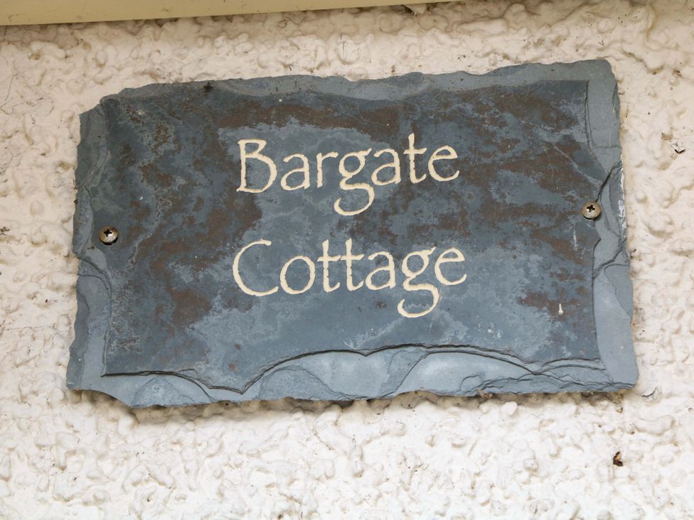 A slate sign with the text Bargate Cottage