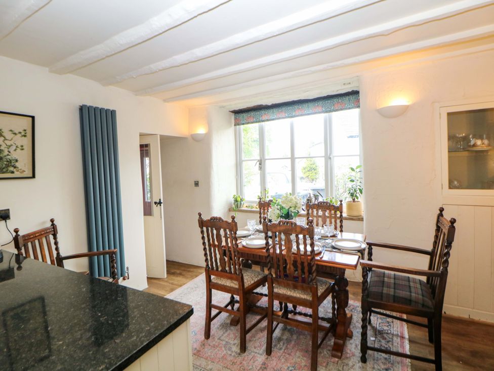 A dining room with a table and chairs at Bargate Cottage in Hope Valley