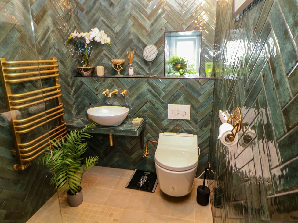 A bathroom with a sink and toilet at Bargate Cottage in Hope Valley