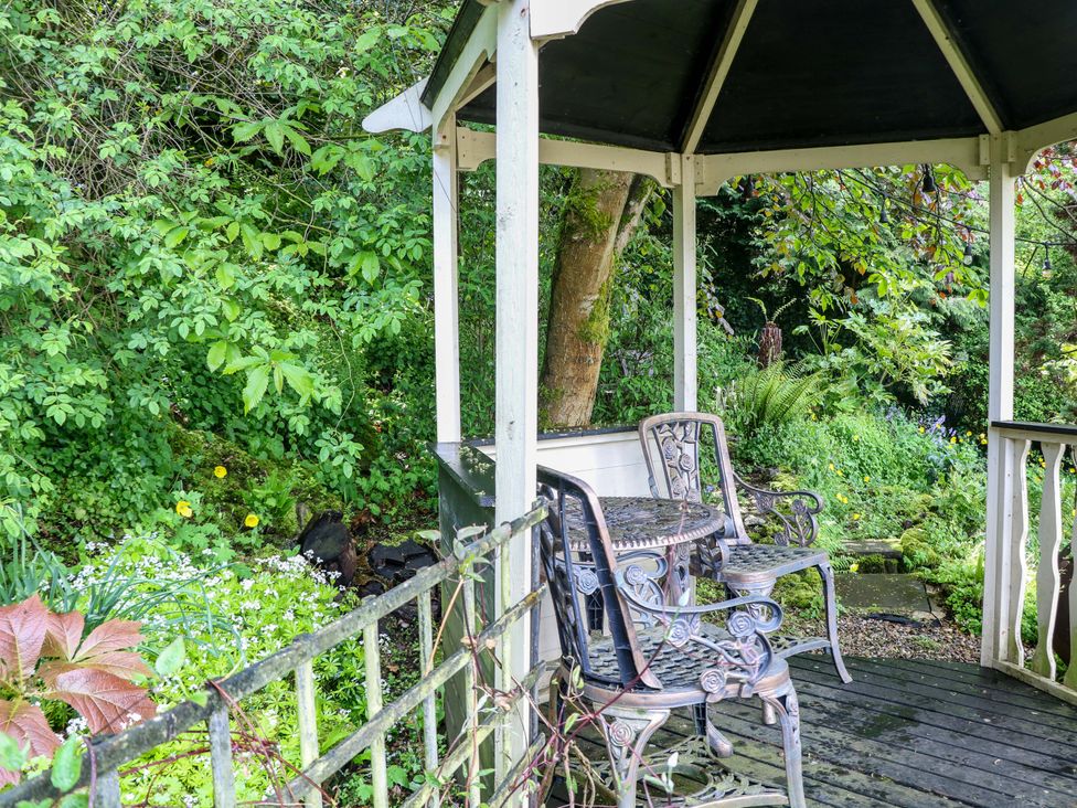 A gazebo with chairs and a table in an outdoor area at Bargate Cottage, Hope Valley