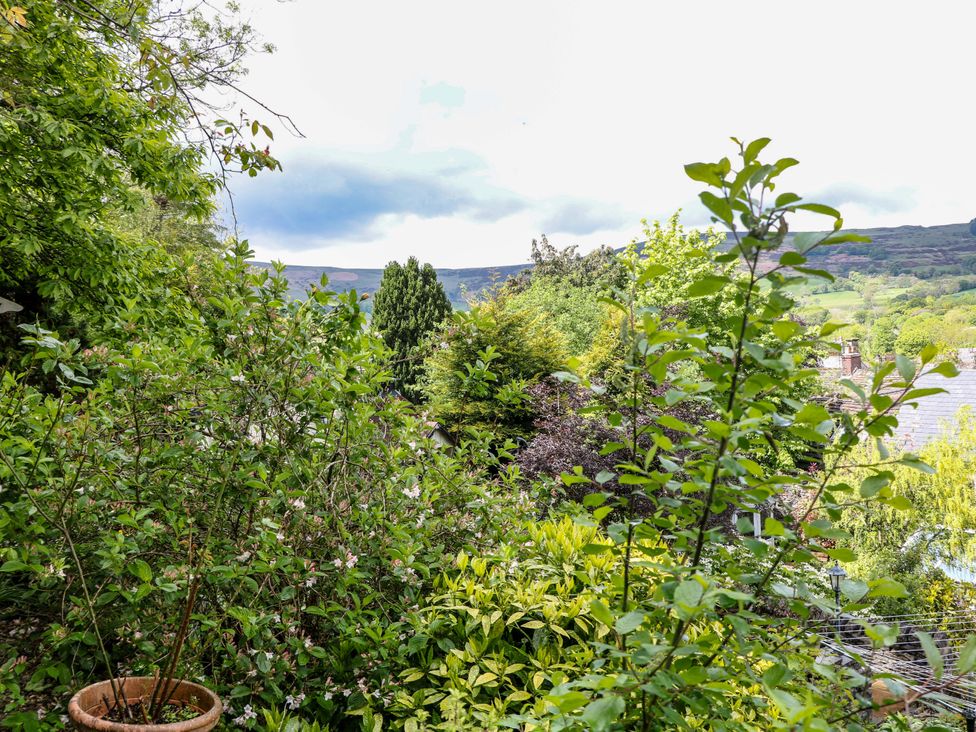 A view of greenery and rooftops at Bargate Cottage in Hope Valley