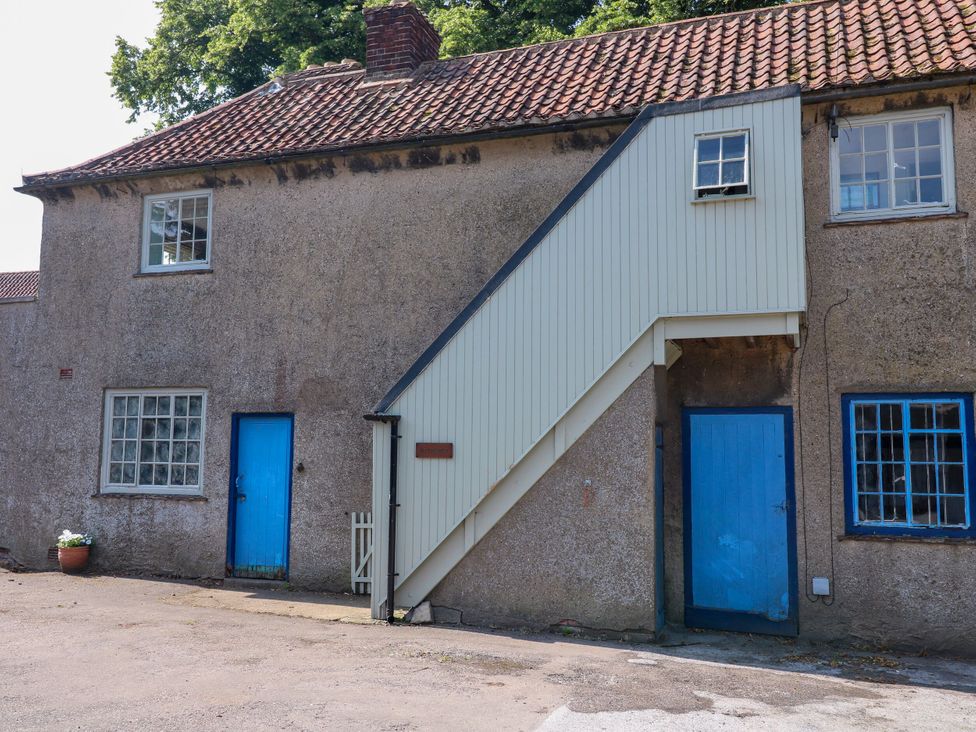 A building with a staircase and blue doors at The Stable Flat in 