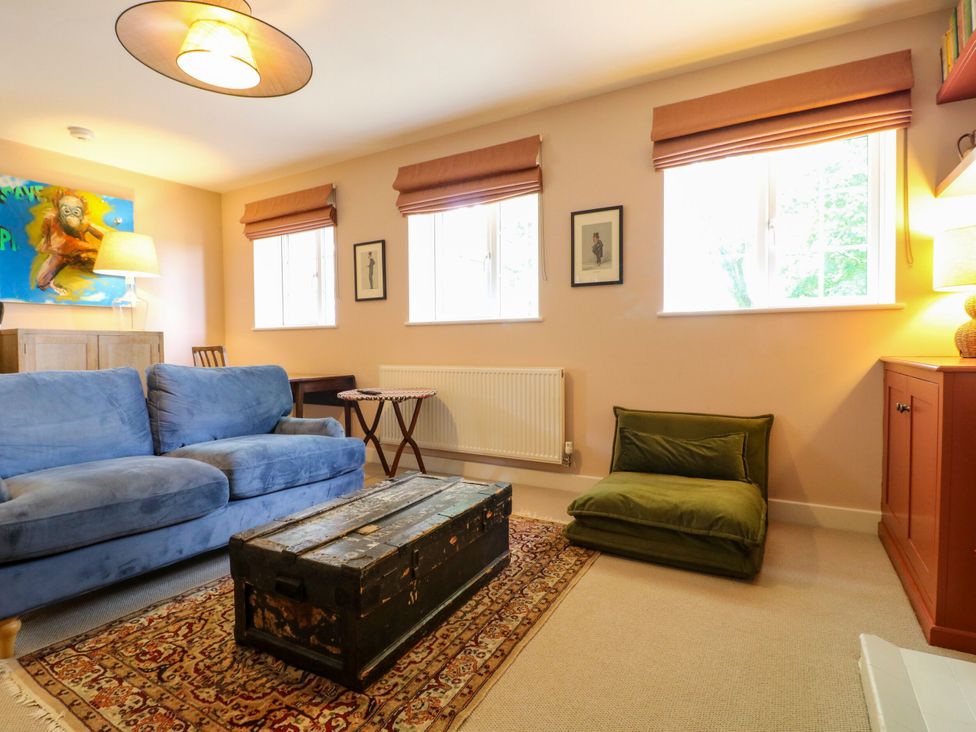 A living room with a blue sofa and a coffee table at The Stable Flat