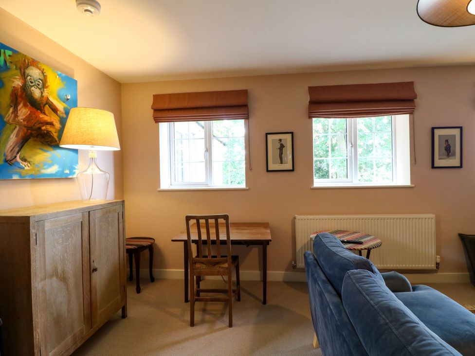 A living room with artwork and furniture at The Stable Flat 