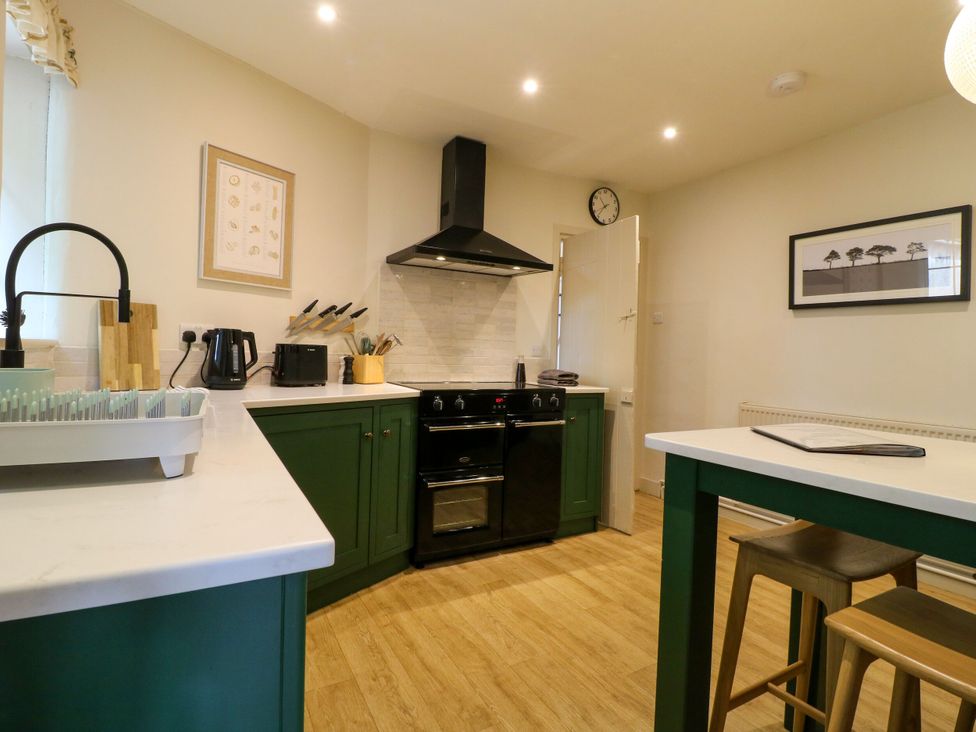 A kitchen with a stove and sink at The Stable Flat