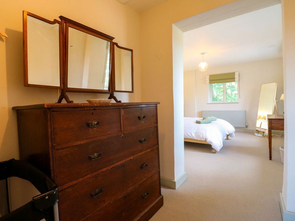 A bedroom with a chest of drawers and bed at The Stable Flat