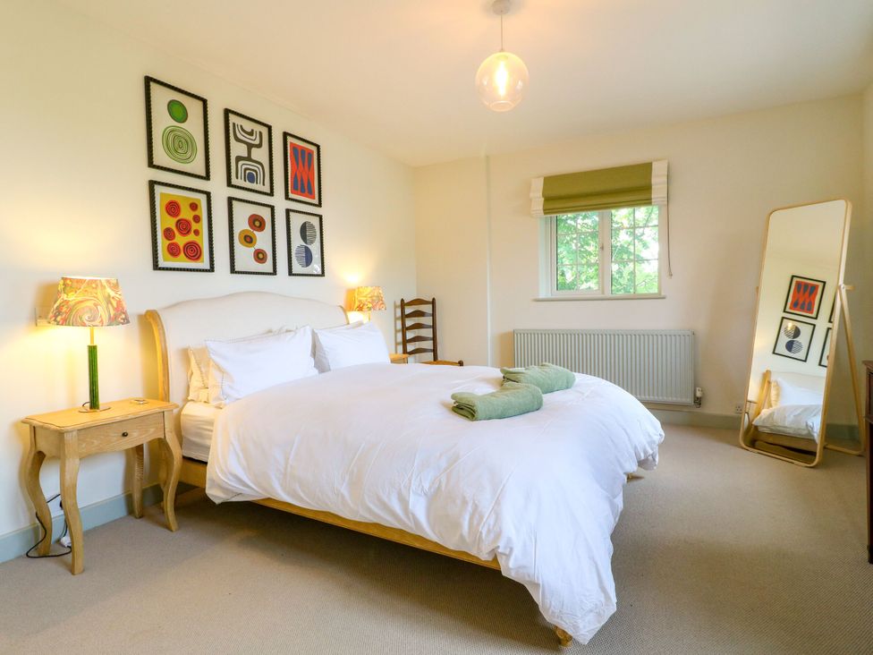 A bedroom with a bed and artwork on the wall at The Stable Flat in 