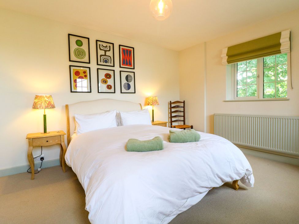 A bedroom with a bed and bedside tables at The Stable Flat 