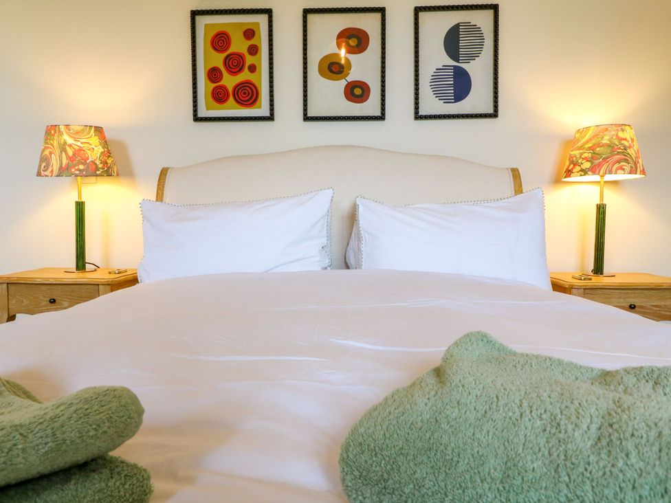 A bedroom with a bed and two lamps at The Stable Flat