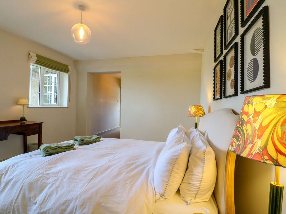 A bedroom with a bed and artwork at The Stable Flat 