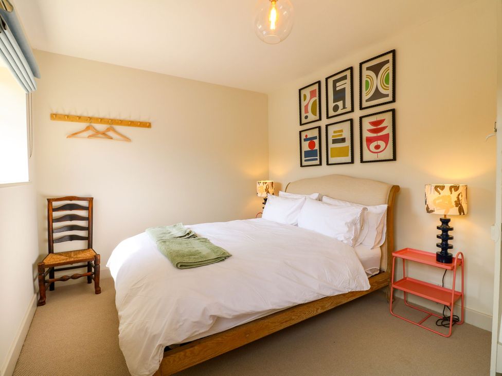 A bedroom with a bed and wall art at The Stable Flat in 