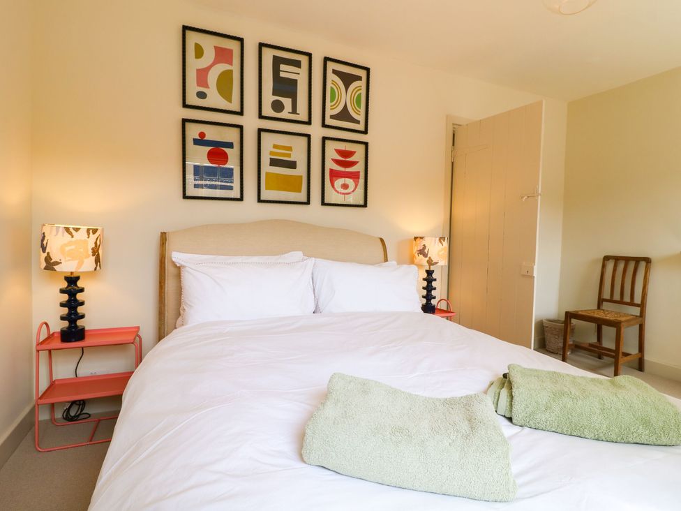 A bedroom with a bed and wall art at The Stable Flat 