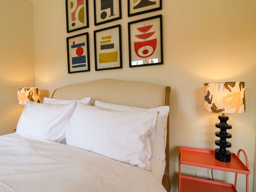 A bedroom with a bed and decorative wall art at The Stable Flat