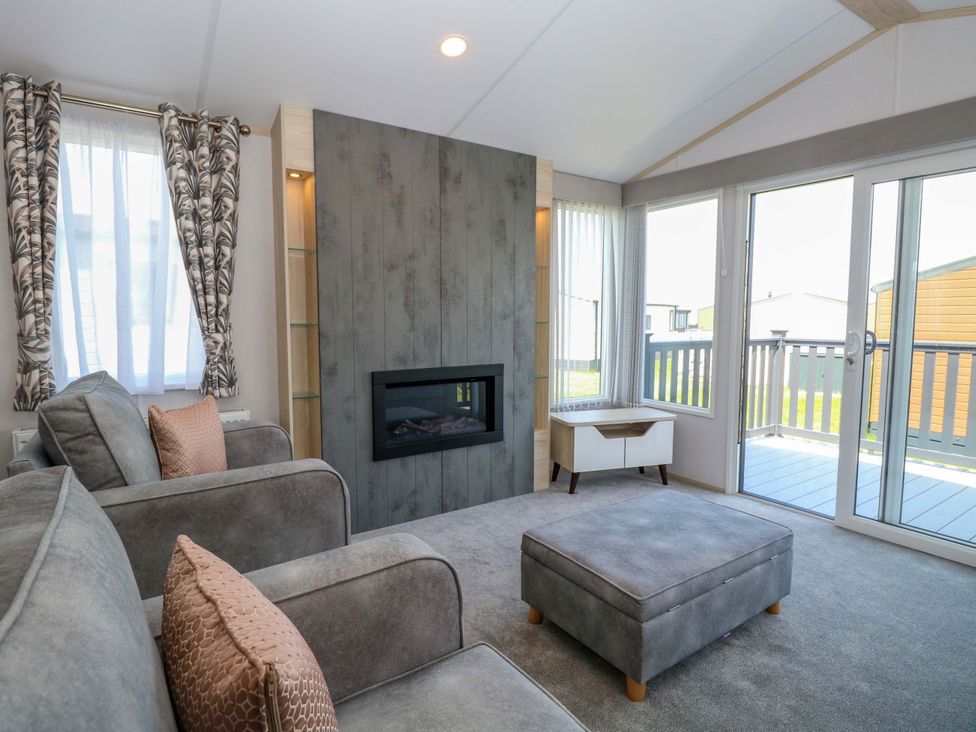 A living room featuring a sofa and fireplace at Sandy Shores Retreat in Norwich