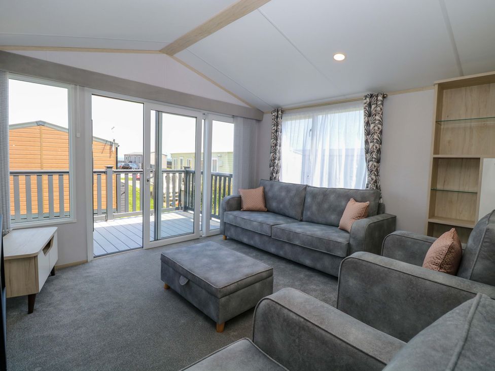 A living room with couches and a coffee table at Sandy Shores Retreat in Norwich
