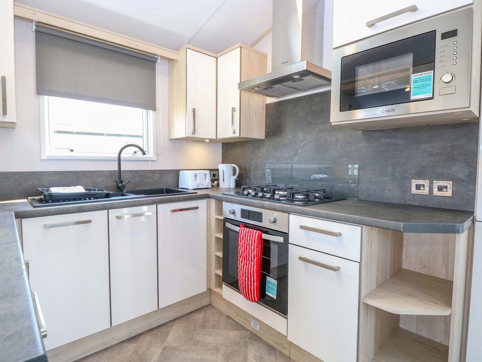 A kitchen with appliances and cupboards at Sandy Shores Retreat in Norwich